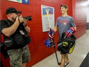 Jesperi Kotkaniemi, the Canadiens’ first-round pick (third overall) at the 2018 NHL Draft, smiles as he walks past photographer after picking up some new equipment on the first day of training camp at the Bell Sports Complex in Brossard on Sept. 13, 2018.