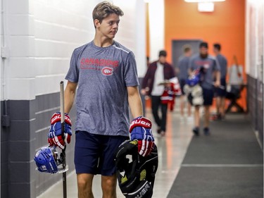 First round draft choice Jesperi Kotkaniemi carries some gear while heading to have photos taken on the first day of the Canadiens' training camp at the Bell Sports Complex in Brossard on Thursday, Sept. 13, 2018.