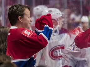 Thomas Chevalier, 12, can barely contain himself as Canadiens players skate by before Sunday's annual Red and White scrimmage at the Bell Centre.