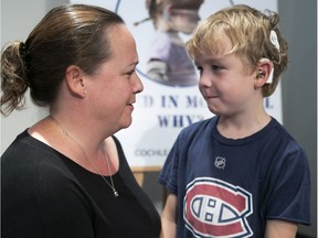 Oscar Geraghty and his mother, Beaconsfield city councillor Dominique Godin, at press conference in Montreal City Hall on Sept. 17, 2018 to help establish a program for cochlear implant surgery.