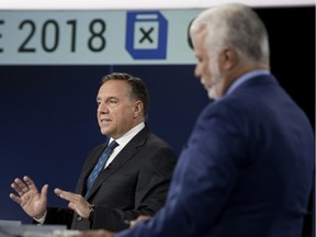 Coalition Avenir Quebec leader François Legault speaks as Liberal Party of Quebec leader Philippe Couillard looks on during English language leader's debate in Montreal Sept. 17, 2018.