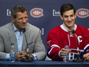MONTREAL, QUE.: SEPTEMBER 18, 2015 -- New team captain Max Pacioretty of the Montreal Canadiens has a laugh with GM Marc Bergevin at a press conference at the Bell Sports Complex in Brossard near Montreal Friday, September 18, 2015.