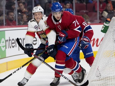 Dryden Hunt of the Florida Panthers and Josh Brook get tied up behind the net during NHL pre-season action in Montreal on Wednesday, Sept. 19, 2018.