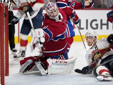 The puck sails past goaltender Carey Price as the Florida Panthers score during a 6 on 4 power play during NHL pre-season action in Montreal on Wednesday, Sept. 19, 2018.