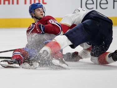 Centre Matthew Peca gets dragged to the ice by Florida Panthers defenseman Aaron Ekblad during NHL pre-season action in Montreal on Wednesday, Sept. 19, 2018.