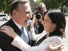 CAQ leader François Legault shares a laugh with Montreal Mayor Valérie Plante during campaign stop in Pointe-aux-Trembles.