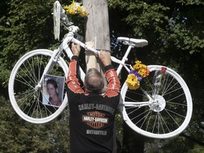 Harold Desrochers, the father of cyclist Valerie Bertrand-Desrochers, puts up ghost bike at the corner of St-Zotique and 19th avenue on Sunday September 23, 2018. Valerie died after a collision with a truck in June. This is the second ghost bike installed in her honour, after the first one disappeared in recent weeks.