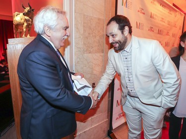 Mario Fortin, president and CEO of Cinéma Beaubien and Cinéma dur Parc, left, welcomes Vincent Labreque, projectionist at Cinéma du Parc to the cocktail reception prior to the opening of the Cinéma du Musée at the Montreal Museum of Fine Arts in Montreal Tuesday, Sept. 25, 2018.