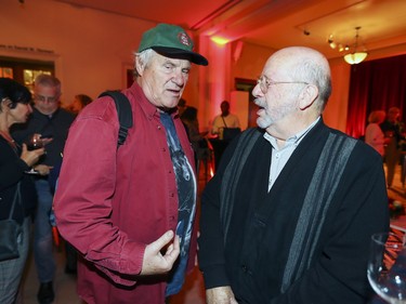 Festival du nouveau cinema founder Claude Chamberland, left, speaks with Jacques Foisy, owner of a cinema in Trois-Rivières, at the opening of the Cinéma du Musée at the Montreal Museum of Fine Arts in Montreal Tuesday, Sept. 25, 2018.