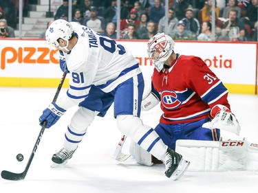 Toronto Maple Leafs' John Tavares deflects a shot in front of Carey Price during first period in Montreal Wednesday, Sept, 26, 2018.