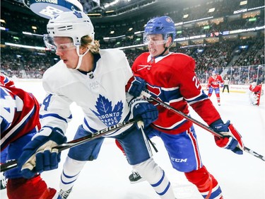 Mike Reilly leans on Toronto Maple Leafs' Kasperi Kapanen during first period in Montreal Wednesday, Sept. 26, 2018.