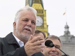 Quebec Liberal Leader Philippe Couillard speaks to reporters at a news conference Friday, September 28, 2018 in Quebec City. A tower disguised as Big Ben is behind as part of an exhibit on London at the Museum of Civilisation.