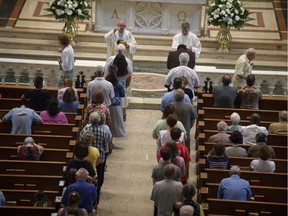 Parishioners worship during a mass to celebrate the Assumption of the Blessed Virgin Mary at St Paul Cathedral, the mother church of the Pittsburgh Diocese on August 15, 2018 in Pittsburgh, Pennsylvania. The Pittsburgh Diocese was rocked by revelations of abuse by priests the day before on August 14, 2018.