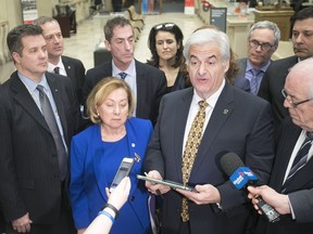 Montreal West mayor Beny Masella, second from right, and other mayors of greater Montreal speak to reporters after adoption of the Montreal budget on Thursday January 25, 2018. Last week, he had a different message: he welcomed the city of Montreal's offer to work with suburban officials on agglomeration governance.