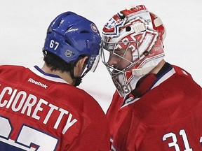 Montreal Canadiens' Max Pacioretty congratulates goalie Carey Price following the Habs' 4-1 victory over the St. Louis Blues in Montreal on Nov. 20, 2014.  Pacioretty scored two goals and was named first star.  Price was named second star.