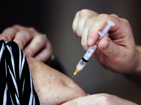 A nurse administers a flu shot at a vaccination clinic set up at the Dollard Civic Centre in Dollard des Ormeaux, west of Montreal Thursday November 24, 2016.