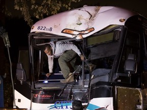 Crews secure a bus before towing after it crashed in to a tree on Newman Blvd. in LaSalle Tuesday night.