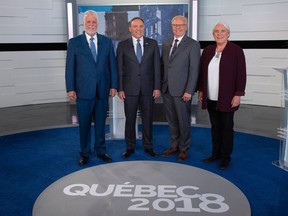 The leaders of Quebec's four main parties pose before Thursday's televised debate. Pollster Jean-Marc Léger says Quebec voters tend to cast ballots "against" rather than "for."