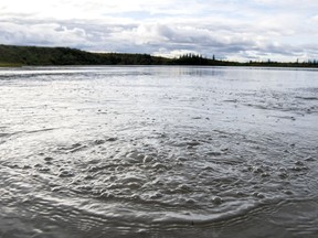 Methane gas released from seep holes at the bottom Esieh Lake ripples the surface.