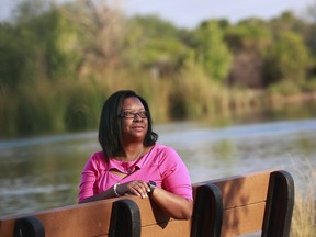In this Aug. 1, 2018, photo, Yvonne Ambrose, mother of murder victim Desiree Robinson, sits at the Riparian Preserve in Gilbert, Ariz. Ambrose's 16-year-old daughter was trafficked in Chicago on Backpage.com and was killed by a buyer on Christmas Eve 2016. Ambrose joined President Donald Trump at the White House when he signed the legislation, the Allow States and Victims to Fight Online Sex Trafficking Act.