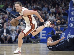 Miami Heat centre Kelly Olynyk, left, gains control of the ball in front of Orlando Magic forward Aaron Gordon on Dec. 30, 2017, in Orlando.