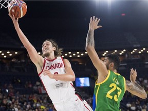 Canada's Kelly Olynyk goes up to the rim as Brazil's Augusto Lima defends during third quarter FIBA Basketball World Cup qualifying action at Place Bell in Laval.