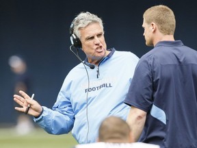 Toronto Argonauts head coach Jim Barker talks to an assistant on the sidelines at the Rogers Centre in 2010.