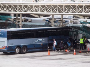 Passengers place their luggage on a Greyhound bus before departing from Vancouver. Seatbelt use on buses has been in the spotlight since April 6, 2018, when a bus carrying the Humboldt Broncos junior hockey team collided with a semi-truck in rural Saskatchewan, killing 16 people and injuring 13.