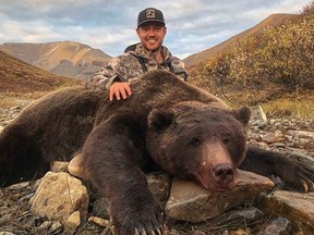 Tim Brent poses with a grizzly bear in this photo from his Twitter page @Brenter37. A former professional hockey player is facing a backlash on social media after he posted photos of a massive grizzly bear he hunted in Yukon. Tim Brent, who was born in Ontario and played for several teams in the NHL, posted the photos on Facebook and Twitter on Sept. 10.THE CANADIAN PRESS/HO, Twitter, @Brenter37