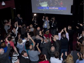 Liberal supporters react as they announce a Quebec Liberal majority government on television during the party celebrations on April 7, 2014, in St-Félicien.