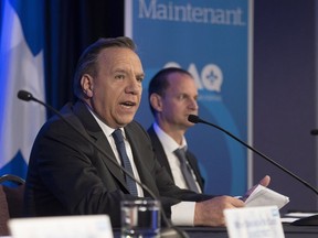 Coalition Avenir Quebec Leader Francois Legault tables his financial platform, Saturday, September 8, 2018 in Quebec City. Groulx candidate Eric Girard, behind, looks on.