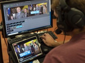 PQ Leader Jean-Francois Lisée is seen on a technician's live stream monitors as he responds to questions during a campaign stop at a youth centre in Montreal Sept. 24, 2018.