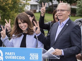 PQ Leader Jean-Francois Lisée, Véronique Hivon and candidates give a victory sign following a news conference during a campaign stop in Acton Vale, Que., on Friday, Sept. 28, 2018.