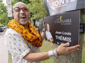 Jean-Louis Themis, leader and only candidate for the Culinary Party of Quebec, is seen with one of his campaign posters on Sept. 19, 2018, in Montreal. Themis is one of many fringe parties vying for seats in the coming provincial election.