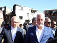 Quebec Liberal Leader Philippe Couillard (right) and Parti Québécois Leader Jean-François Lisée (left) survey the damage caused by a tornado, in Gatineau, Que., Saturday, September 22, 2018. THE CANADIAN PRESS/Fred Chartrand