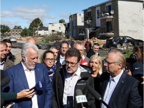 Quebec Liberal Leader Philippe Couillard along with Gatineau Mayor Maxime Pedneaud-Jobin and Parti Québécois Leader Jean-François Lisée (left to right) hold a news conference as they survey the damage caused by a tornado in Gatineau on Saturday, Sept. 22, 2018.