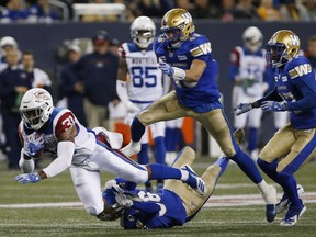 Montreal Alouettes' William Stanback (31) gets hauled down by Winnipeg Blue Bombers' Marcus Sayles (36) during the first half of CFL action in Winnipeg Friday, September 21, 2018.