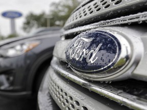 FILE - In this Jan. 12, 2015, file photo, Ford vehicles sit on the lot at a car dealership, in Brandon, Fla. Ford Motor Co. will export vehicles from China to the U.S. for the first time starting in 2019, announced Tuesday, June 20, 2017. Ford will move production of its Ford Focus small car from the U.S. to China, where it already makes the Focus for Chinese buyers. (AP Photo/Chris O'Meara, File) ORG XMIT: NYAG202