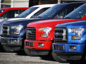 In this Nov. 19, 2015, file photo a row of 2015 Ford F-150 pickup trucks are parked on the sales lot at Butler County Ford in Butler, Pa.