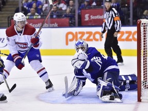 Toronto Maple Leafs goaltender Garret Sparks (40) makes a save on Montreal Canadiens left winger Charles Hudon (54) as Leafs defenceman Martin Marincin (52) looks on during third period NHL preseason action in Toronto, Monday, Sept. 24, 2018.