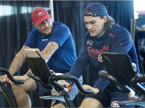 Canadiens' Nicolas Deslauriers, left, and Jonathan Drouin ride stationary bikes during training camp at the Bell Sports Complex in Brossard on Sept. 13, 2018.