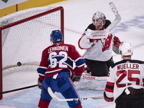 Montreal Canadiens' Artturi Lehkonen and New Jersey Devils' Mirco Mueller watch the puck go past New Jersey Devils goaltender Mackenzie Blackwood on a goal by Canadiens' Jesperi Kotkaniemi during third-period pre-season action Monday, Sept. 17, 2018 at the Bell Centre.