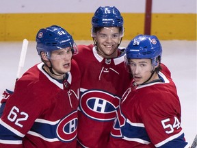 Montreal Canadiens' Jesperi Kotkaniemi, centre, celebrates his goal with teammates Artturi Lehkonen, left, and Charles Hudon as they face the New Jersey Devils during third period pre-season NHL hockey action Monday, September 17, 2018 in Montreal.