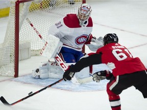 Senators' Mark Stone tries to corral a bouncing puck in front of Canadiens goaltender Carey Price during first period NHL pre-season action on Saturday, Sept. 29, 2018, in Ottawa.