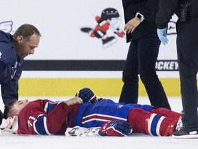 Canadiens forward Jake Evans lies injured on the ice after being hit by Ottawa Senators defenceman Jonathan Aspirot during third period of NHL Rookie Showdown game at Place Bell in Laval on Sept. 7, 2018.