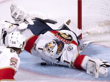Florida Panthers goaltender Roberto Luongo falls onto the puck to make the save as they face the Montreal Canadiens during second period NHL hockey action in Montreal on Wednesday, Sept. 19, 2018.
