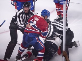 Montreal Canadiens' Max Domi is pulled away by linesman Ryan Daisy after a brief fight with Florida Panthers' Aaron Ekblad during third period NHL hockey action in Montreal on Wednesday, September 19, 2018.