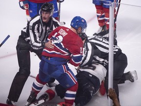 Canadiens' Max Domi is pulled away by linesman Ryan Daisy after a brief fight with Florida Panthers' Aaron Ekblad during third period action in Montreal on Sept. 19, 2018.