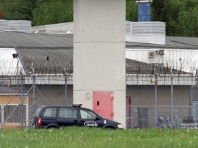 Security van passes under guard tower on its rounds around the perimeter of Donnacona maximum security prison in Donnacona in 2001.