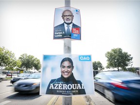 Election posters for Liberal candidate Carlos Leitão and the CAQ's Laura Azeroual, running in the Robert-Baldwin riding, on Sources Blvd. in Dollard-des-Ormeaux.